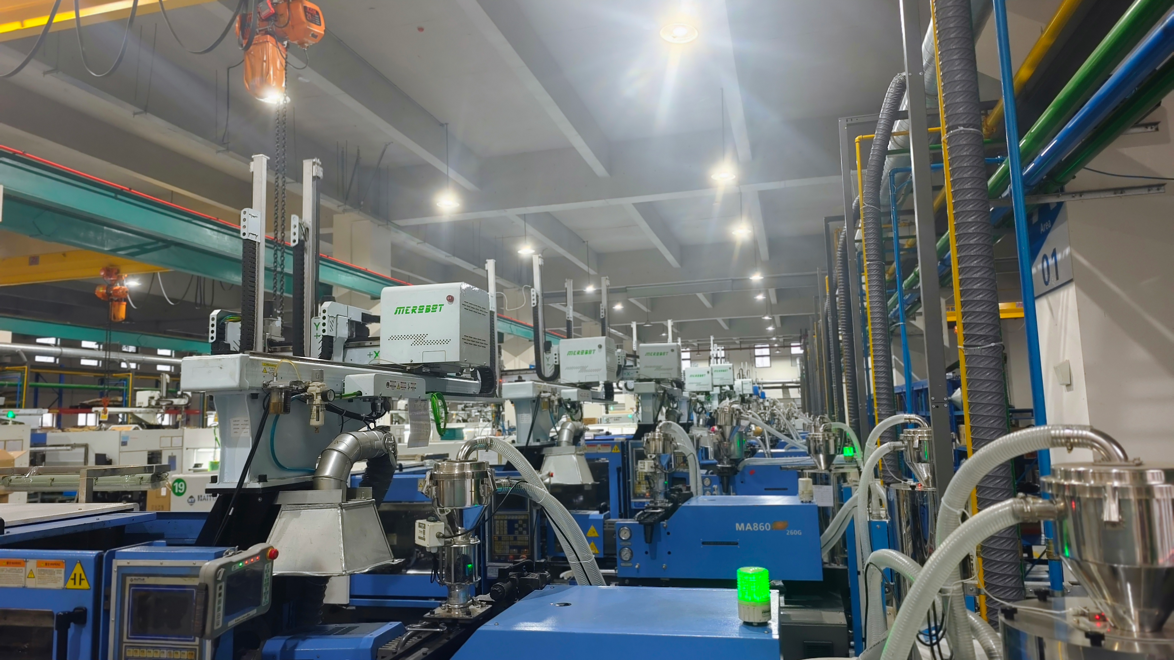 Rows of injection molding machines equipped with automated material feeding and take-out systems